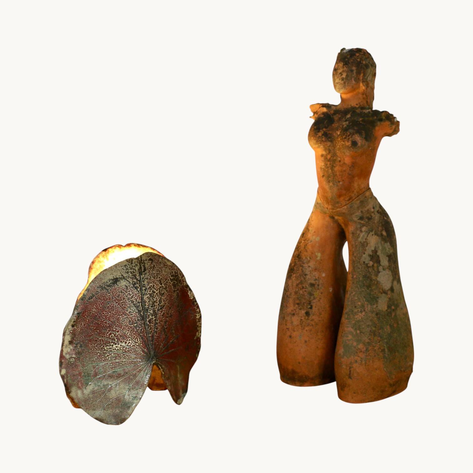 A ceramic lamp in the shape of a leaf.