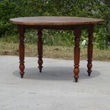 Round drop-leaf table made entirely of solid walnut
