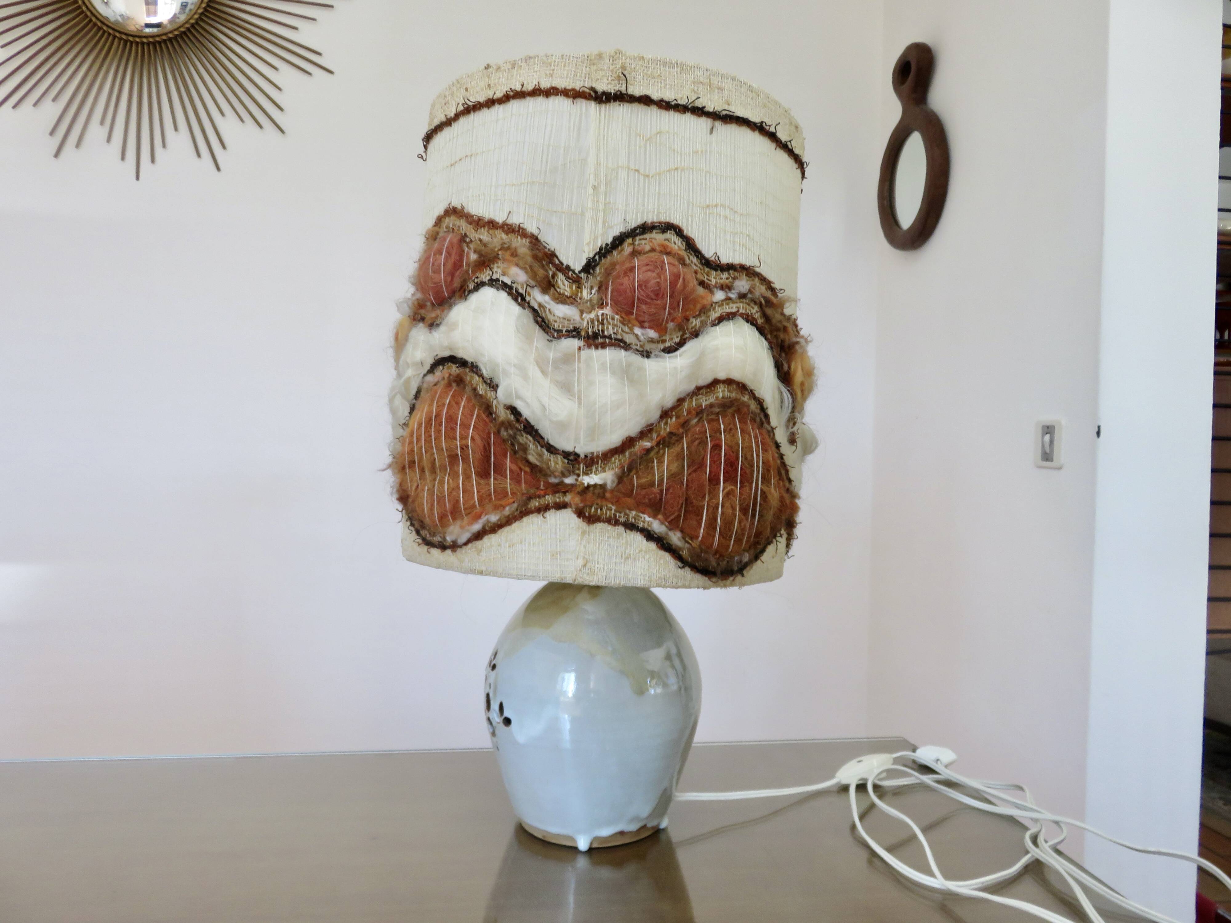 Ceramic lamp with double lighting and openwork design.