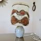 Ceramic lamp with double lighting and openwork design.