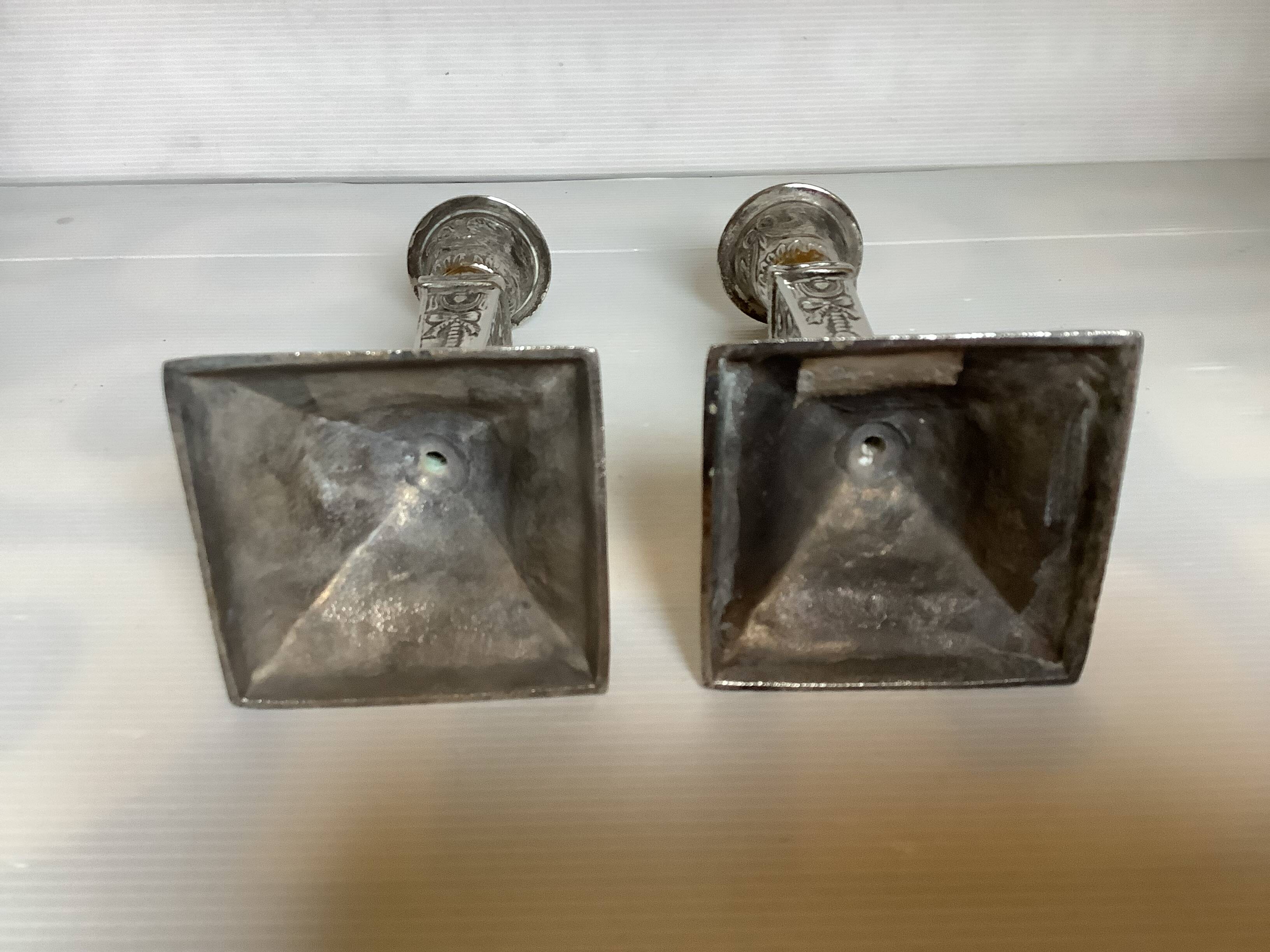 Pair of ornate silver candlesticks