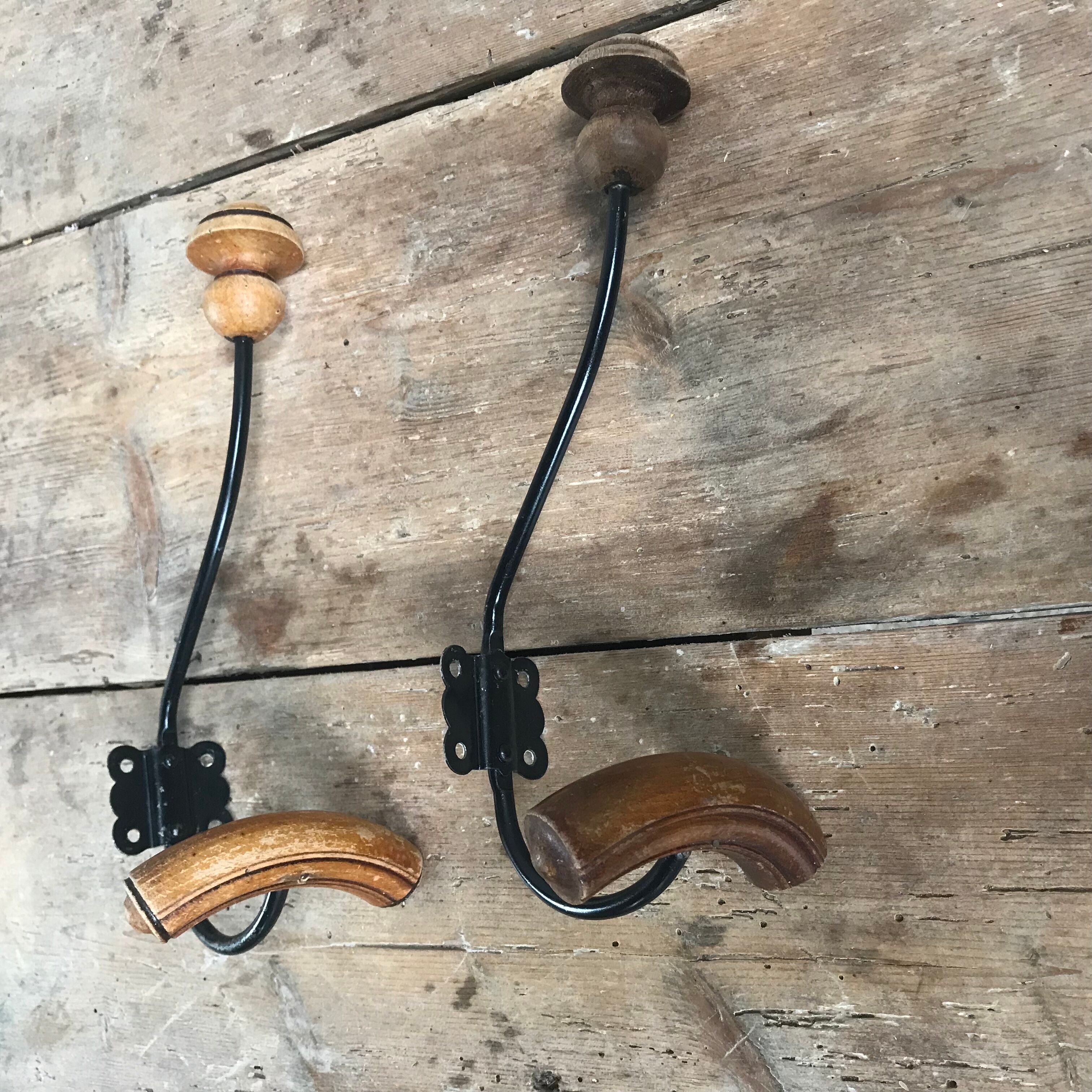 Pair of old wood and metal hooks