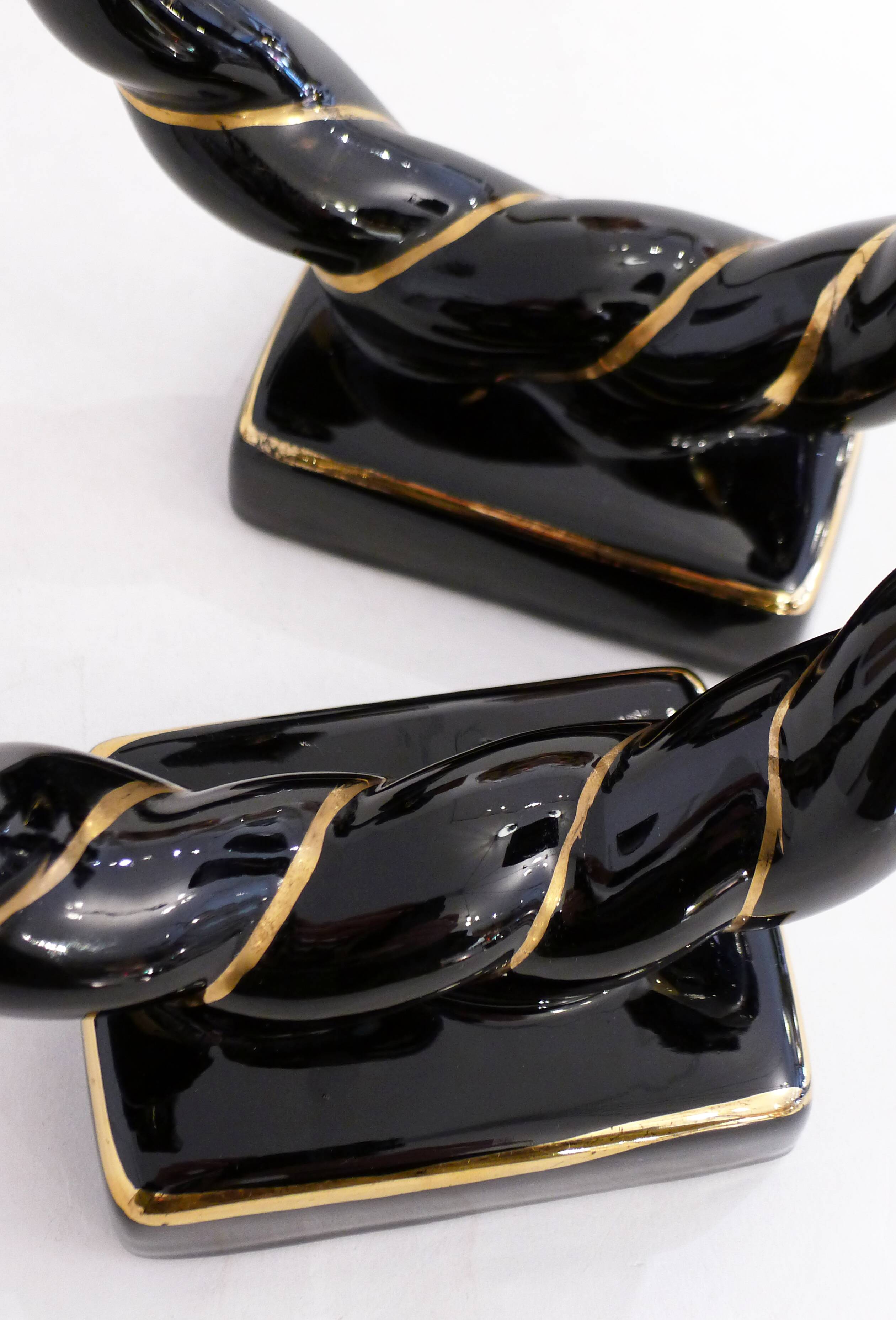 Pair of earthenware braided rope candlesticks