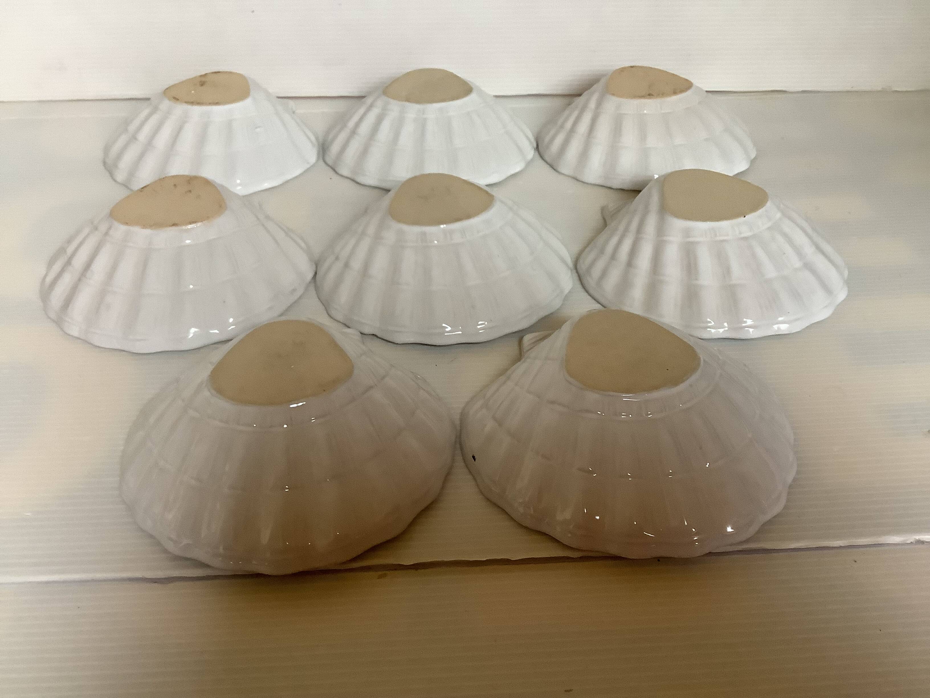 Eight white scallop shell bowls