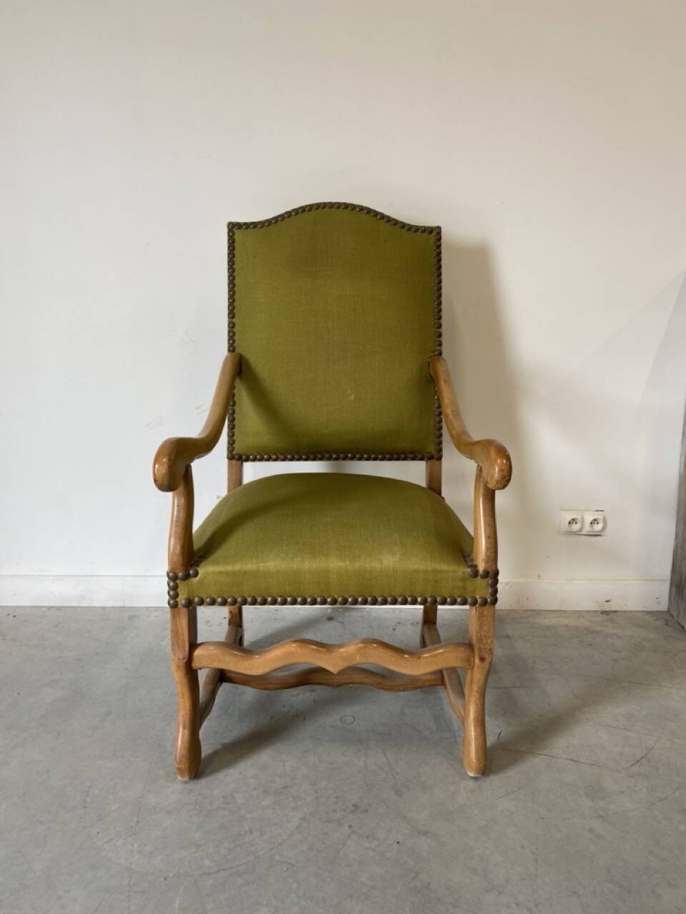 Olive green upholstered armchairs with studs