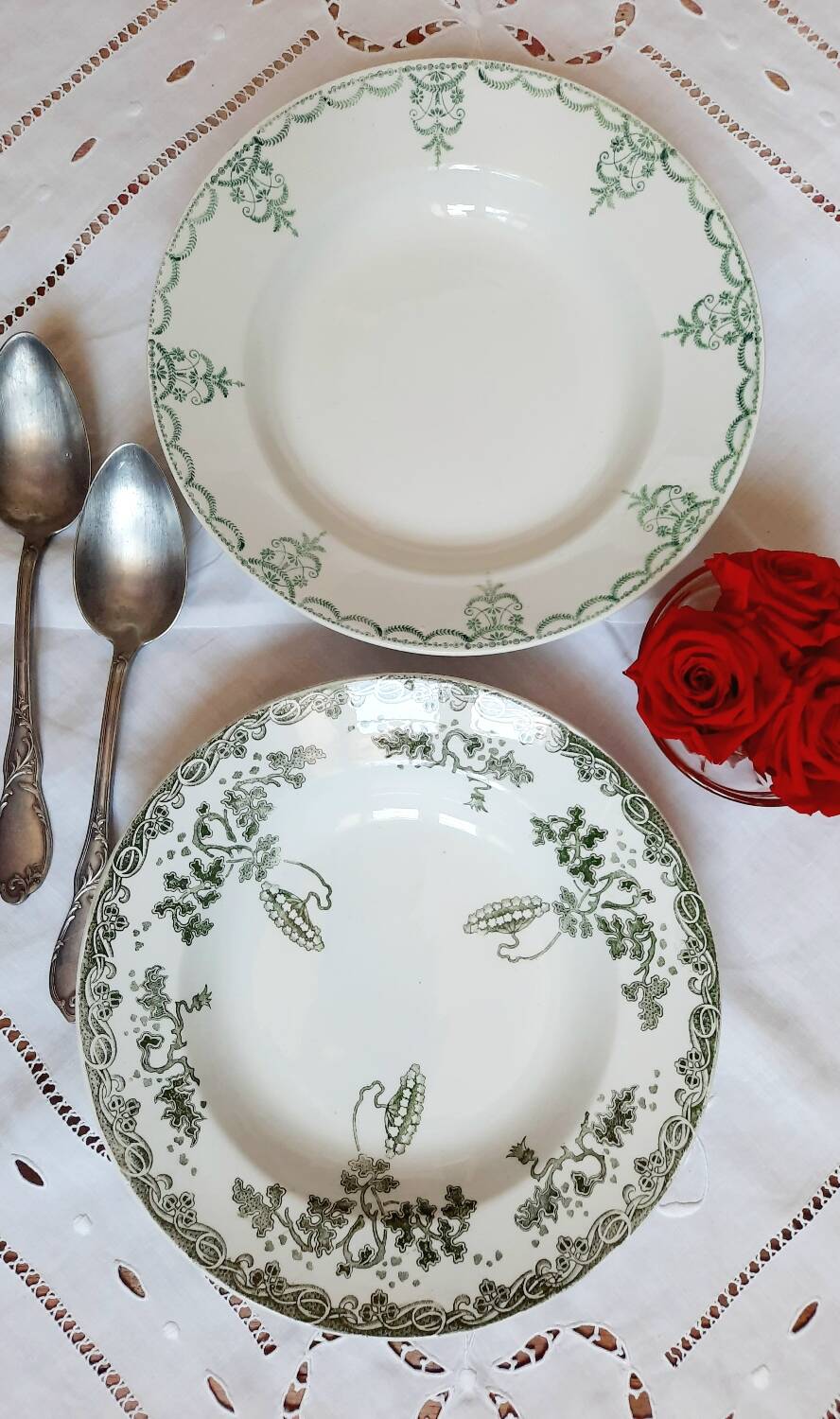 Old mismatched hollow plates in iron earth earthenware accompanied by a soup tureen