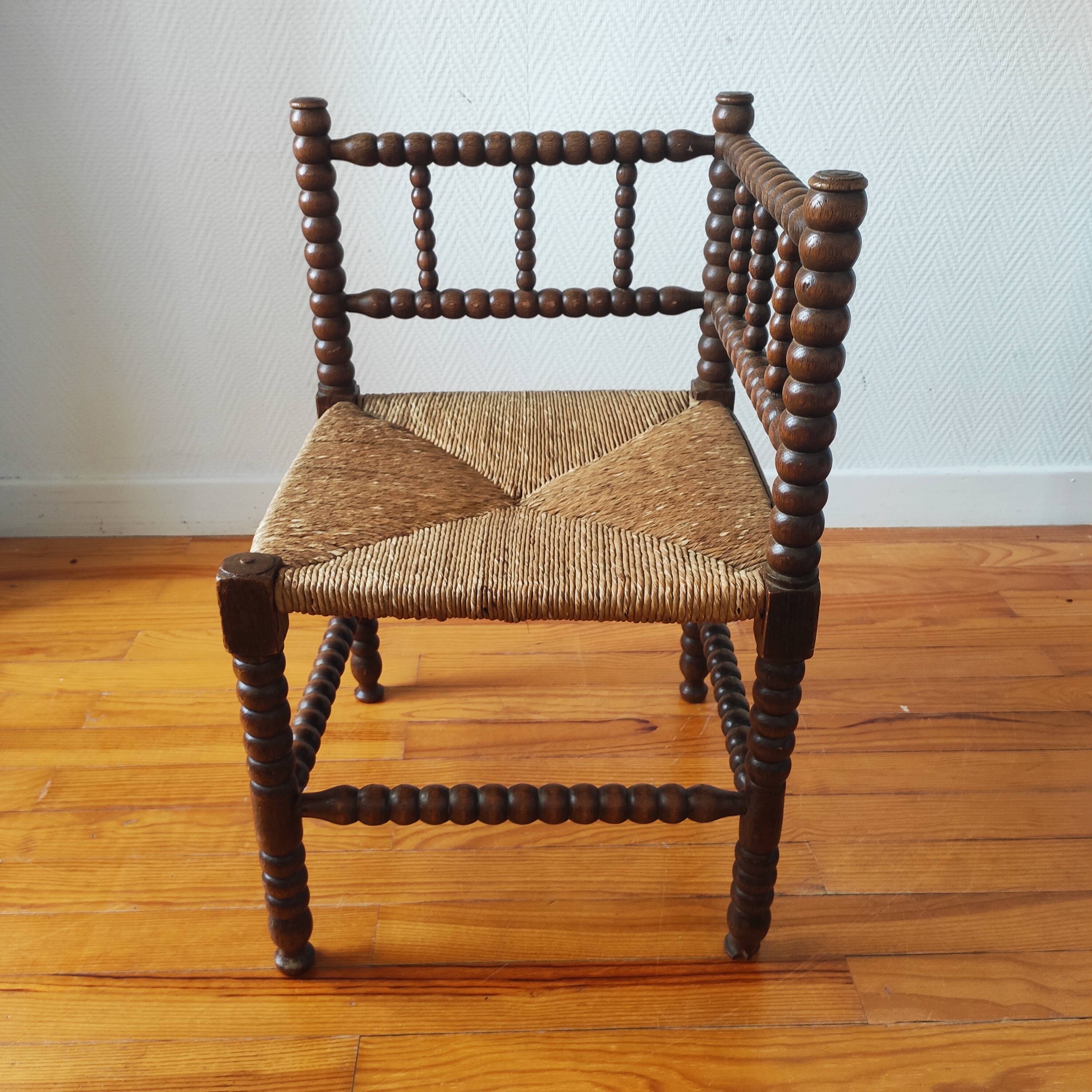Antique corner chair made of turned wood spindle.