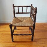 Antique corner chair made of turned wood spindle.