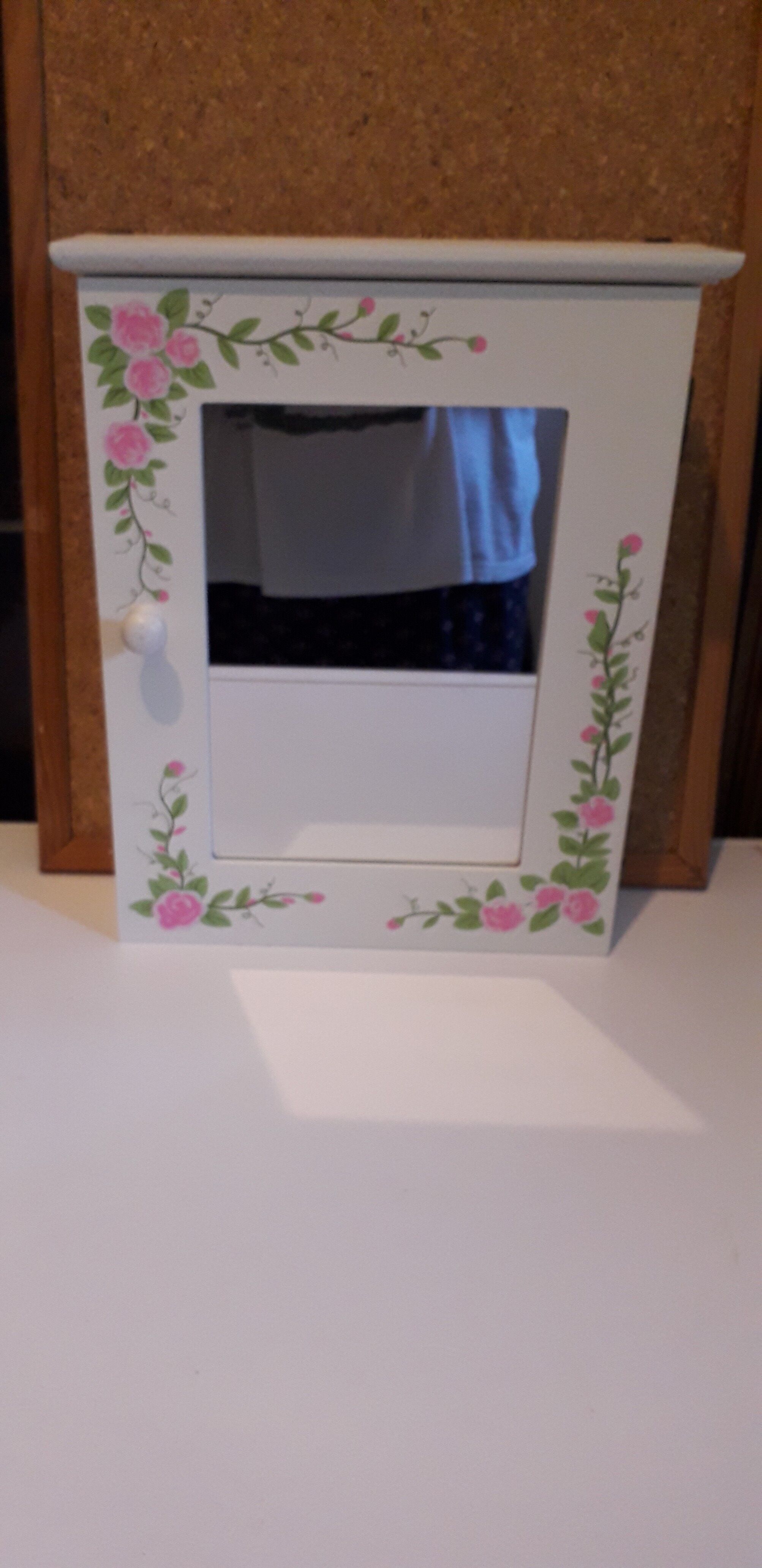 White mirrored toilet cabinet with floral pattern