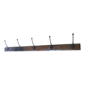 Antique coat rack made of wood and cast iron.
