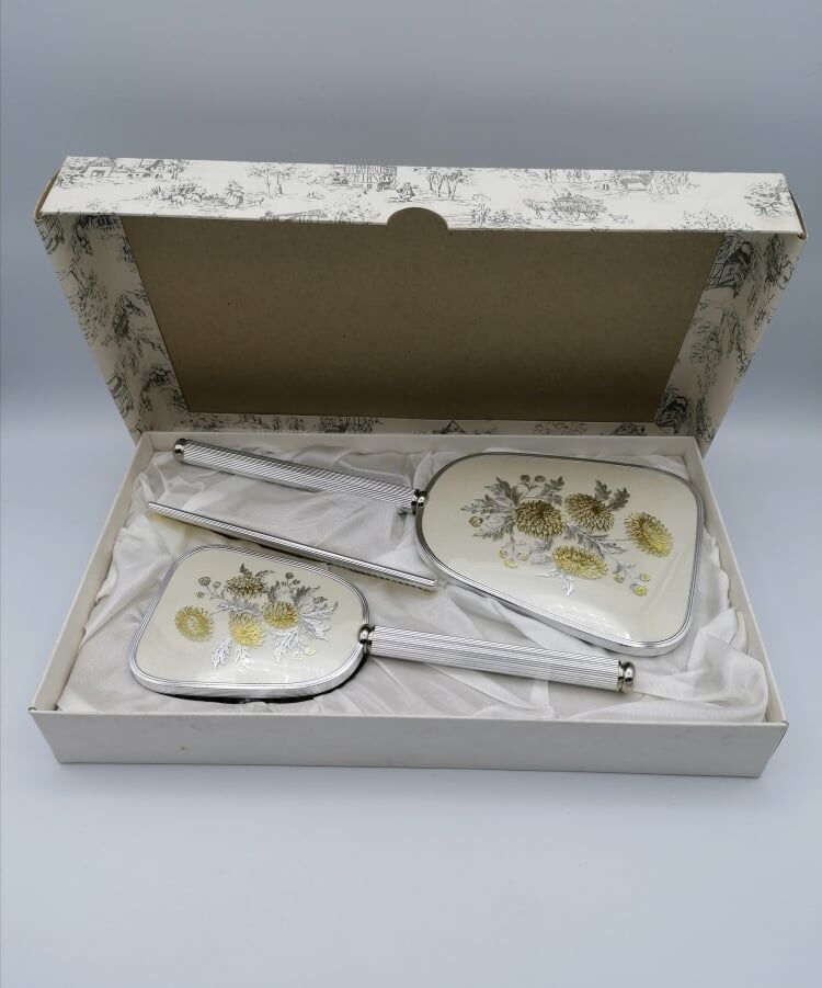 Hand mirror assembly, comb and brush.