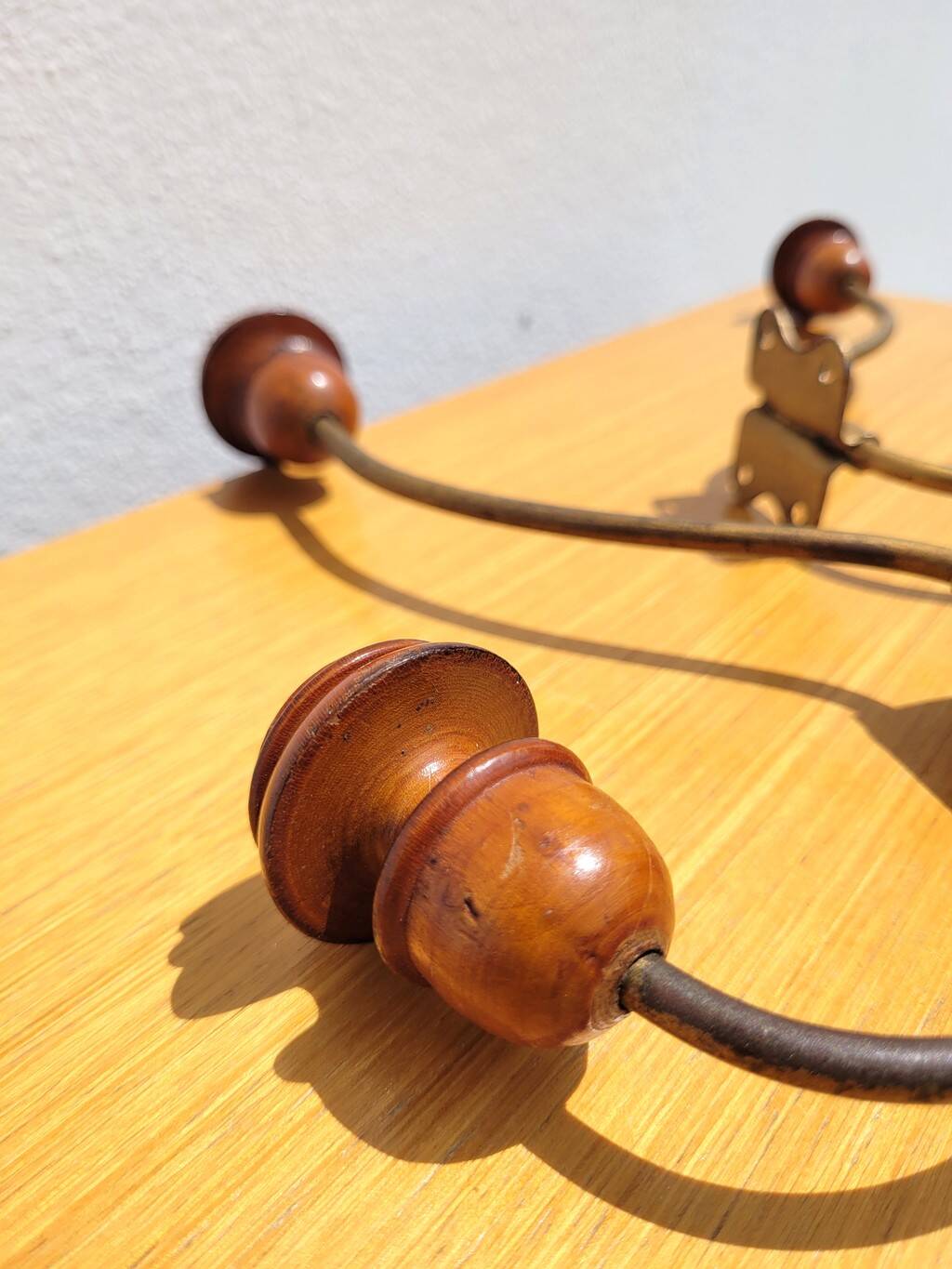 Pair of antique wooden and metal coat hooks