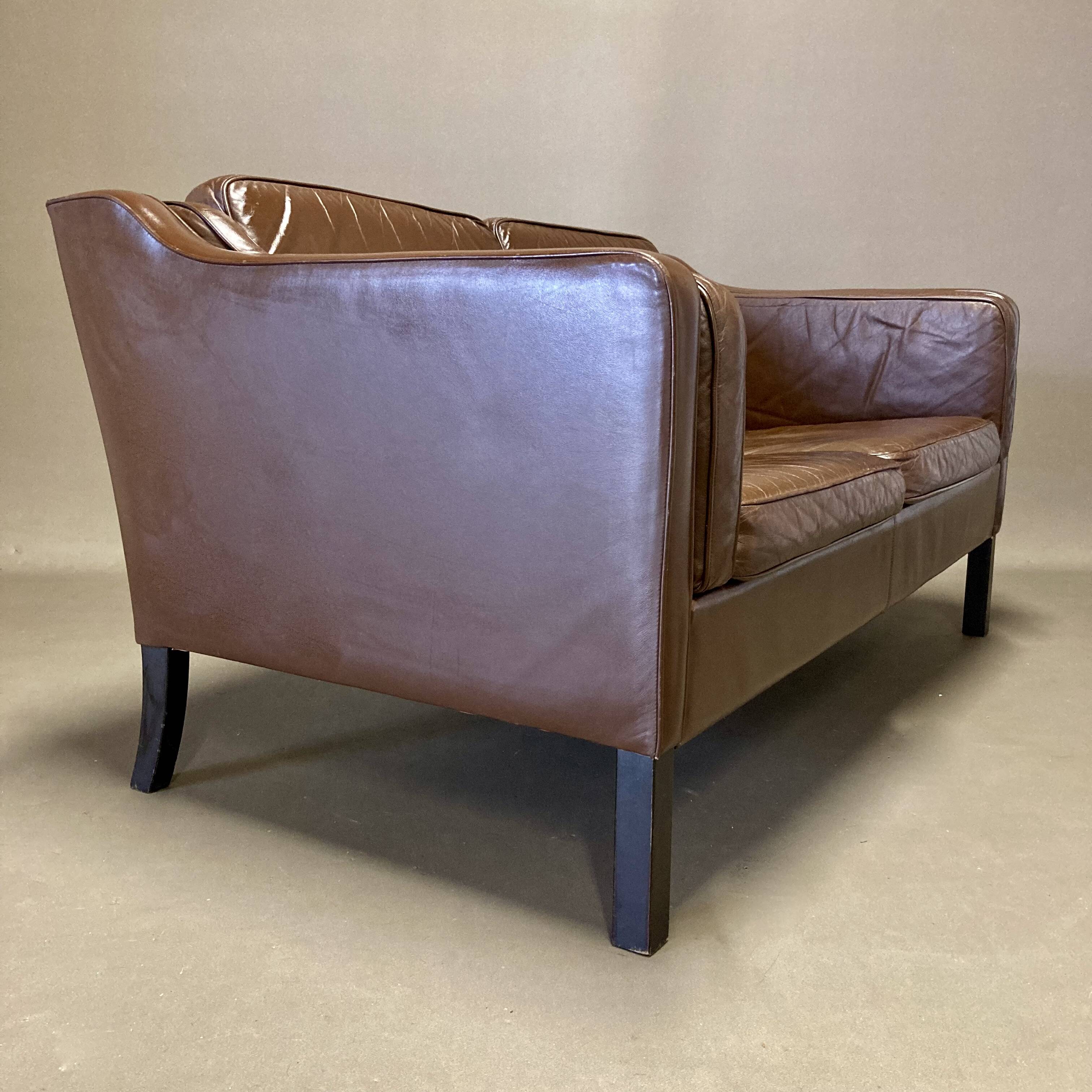 Scandinavian design 2-seater leather sofa.