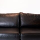 Two seater sofa upholstered with black leather and of danish design