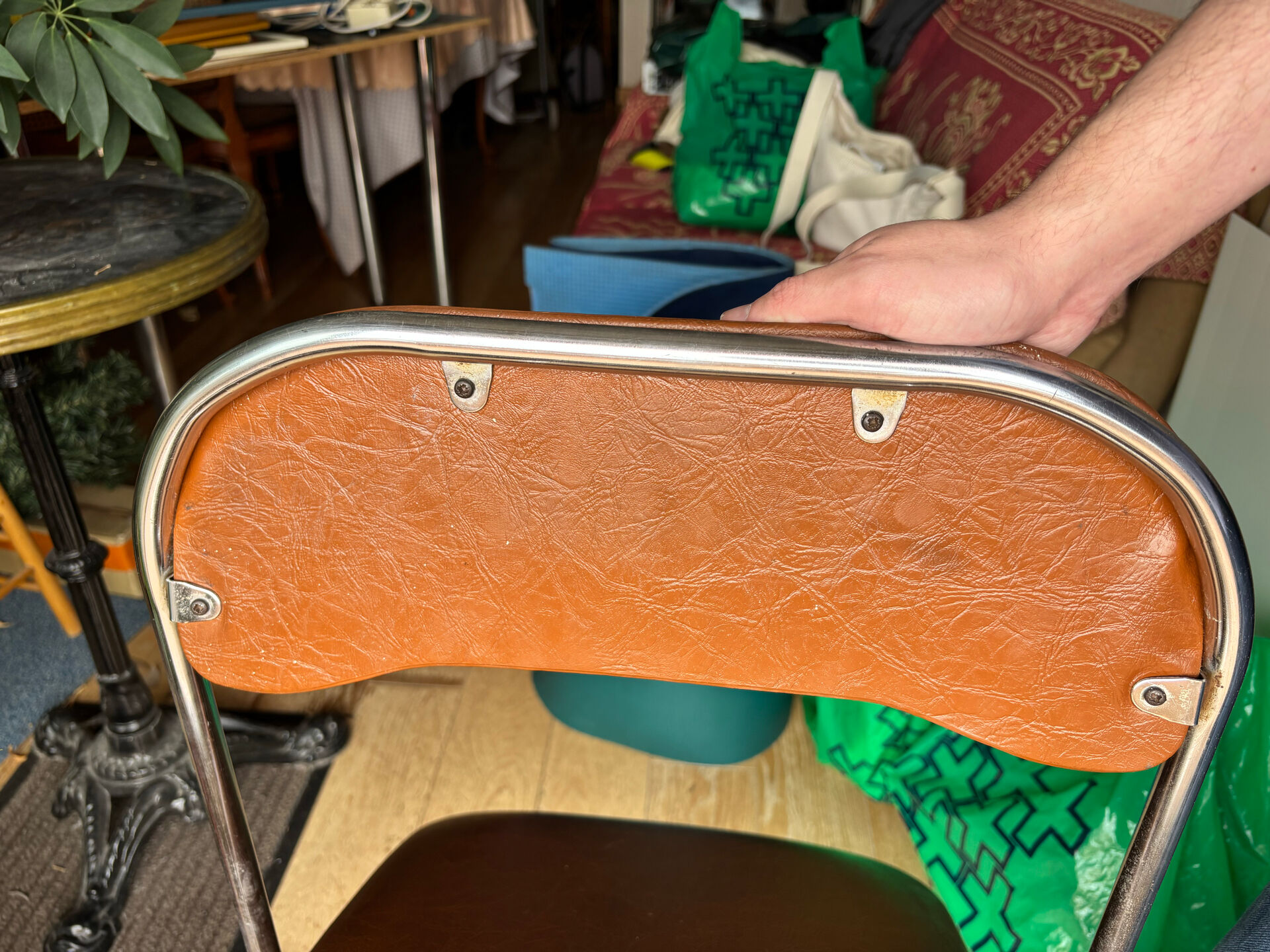 Brown folding chair in vinyl and steel