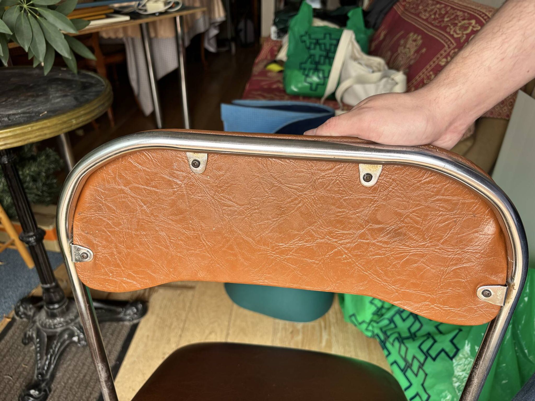 Brown folding chair in vinyl and steel