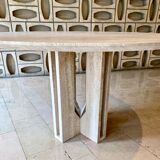 Round travertine dining table with double cross foot