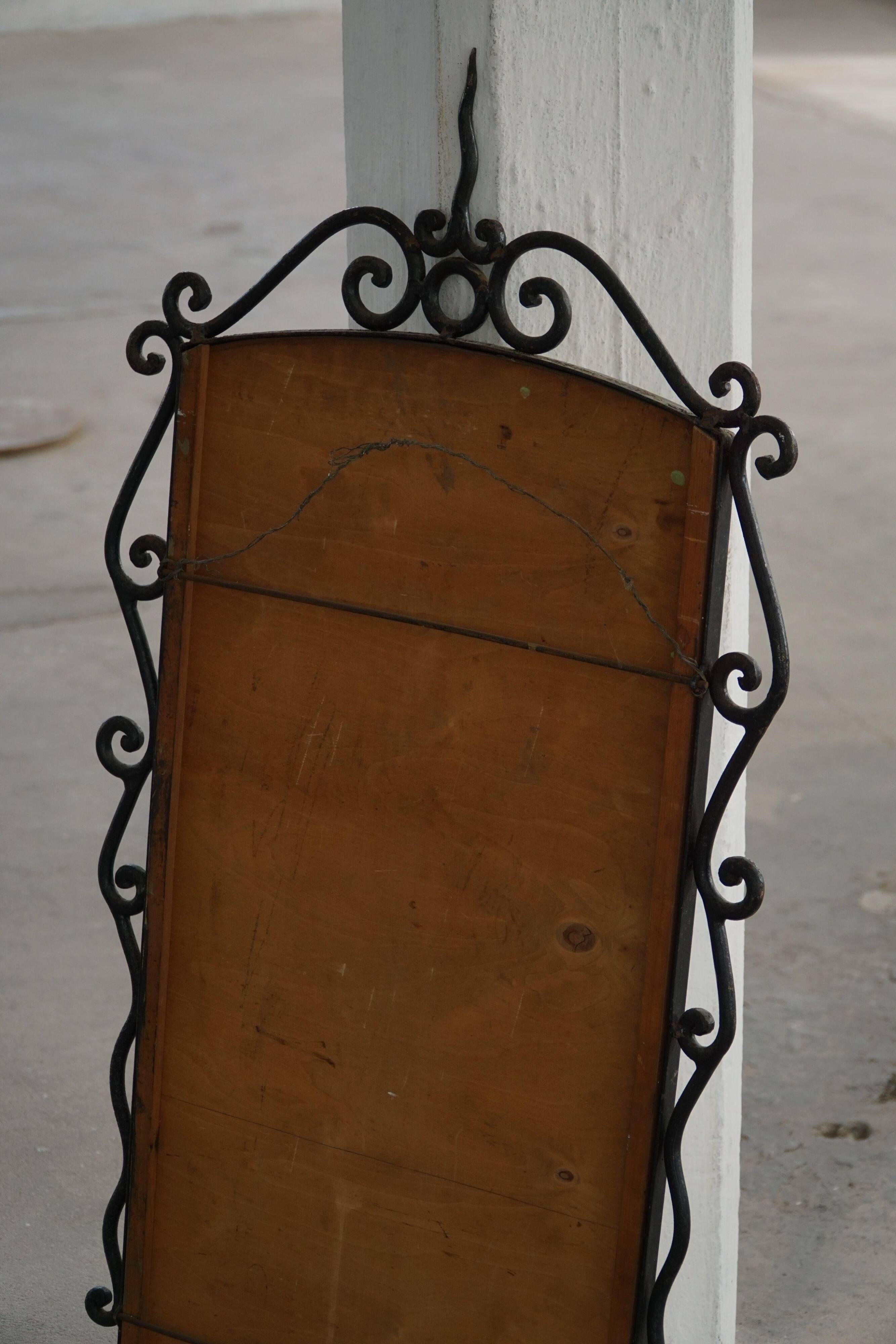 French mid-century brutalist wall mirror in wrought iron, made in the 1950s.