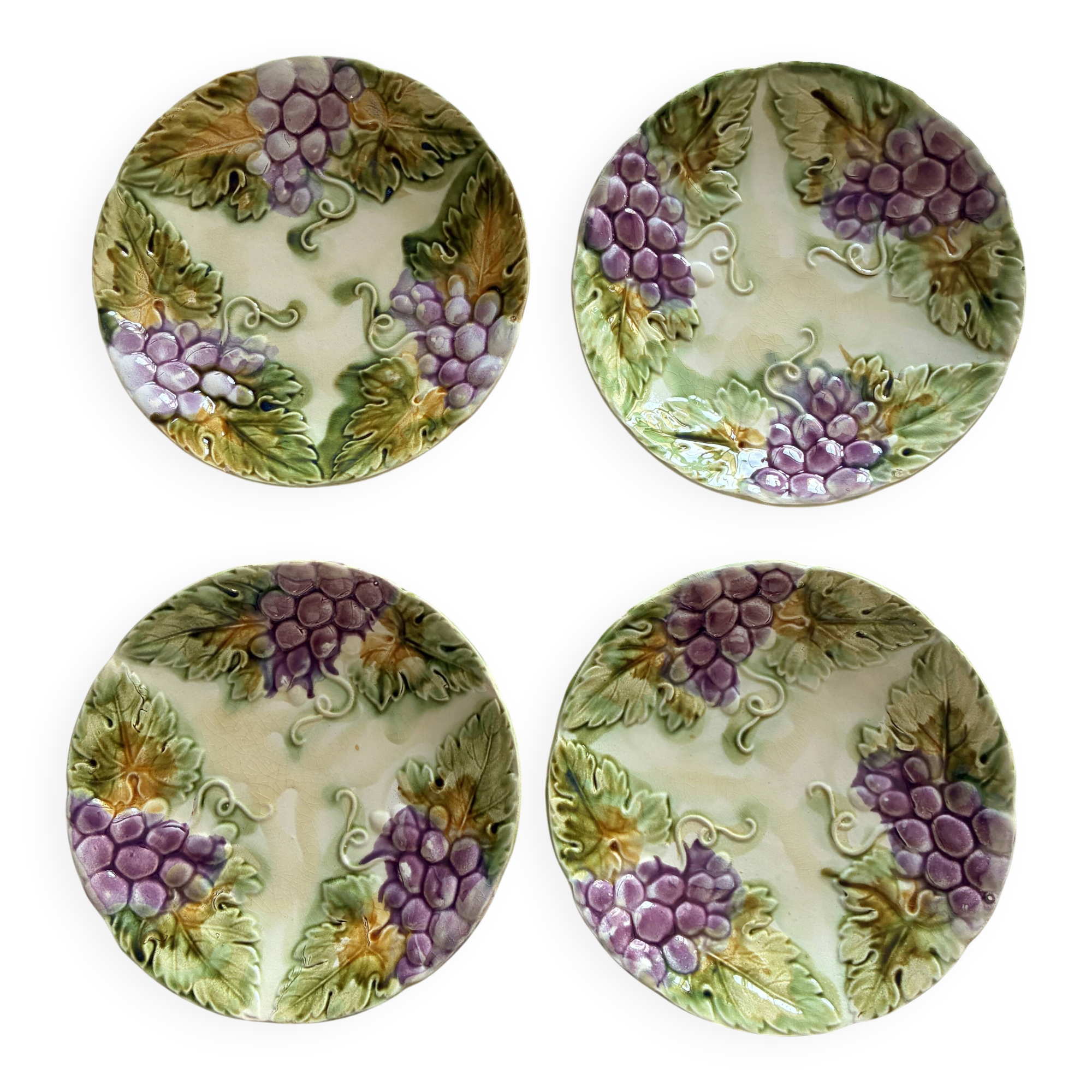 Lot of 4 Onnaing barbotine plates with grapevine design.