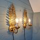 Pair of gold metal wall sconces in Hollywood Regency style, 1970s.