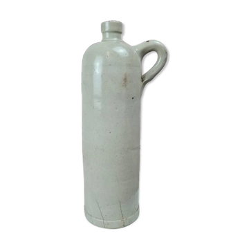 Antique beige glazed stoneware bottle from the 19th century, with a handle, vintage decor.