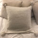 White cushion cover with pom poms
