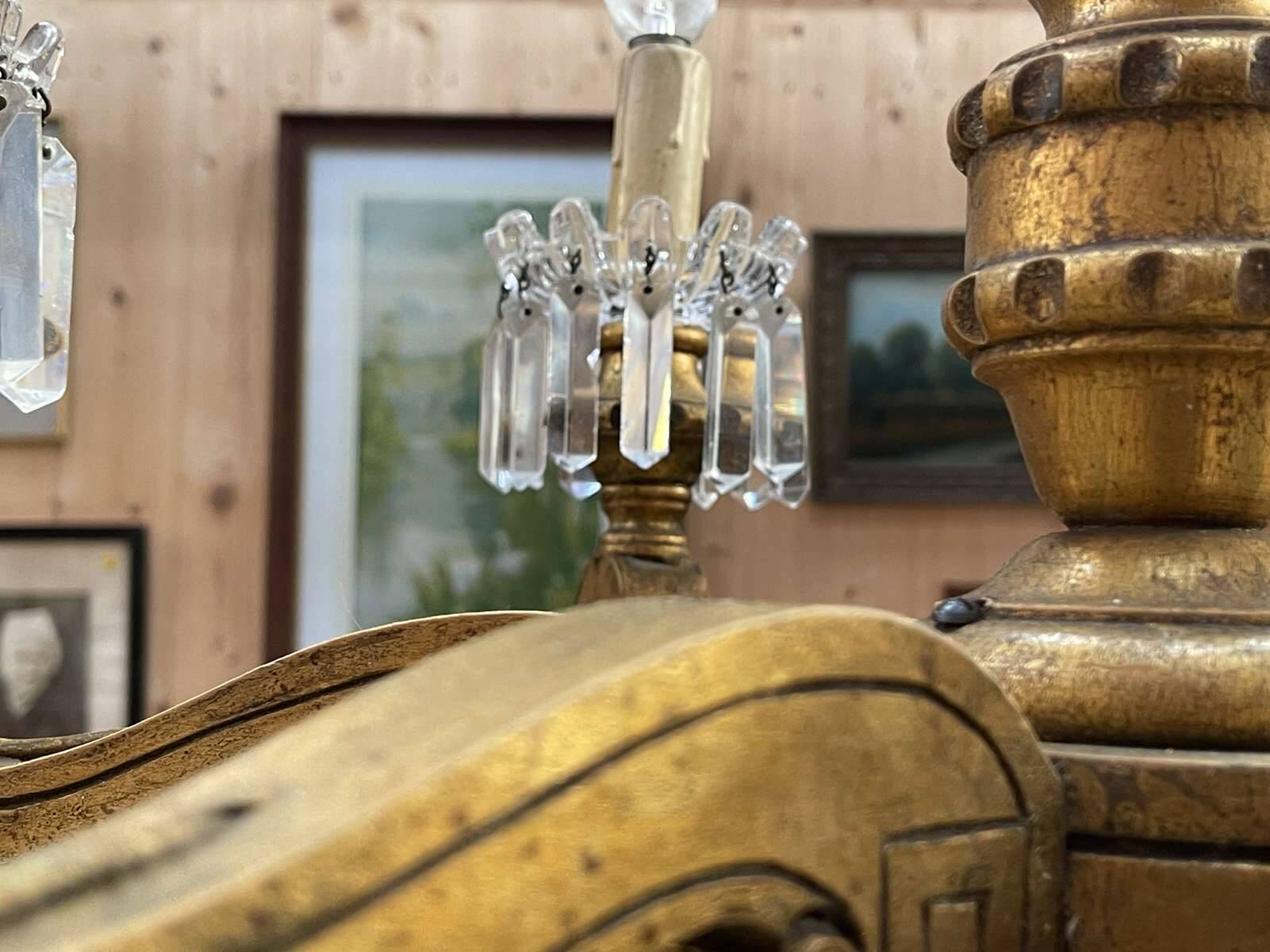 Golden wooden chandelier with crystal pendants from the 19th century.