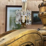 Golden wooden chandelier with crystal pendants from the 19th century.