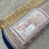 Vintage mechanical Turkish rug with box decoration on a red and navy blue background 139 x 68 cm
