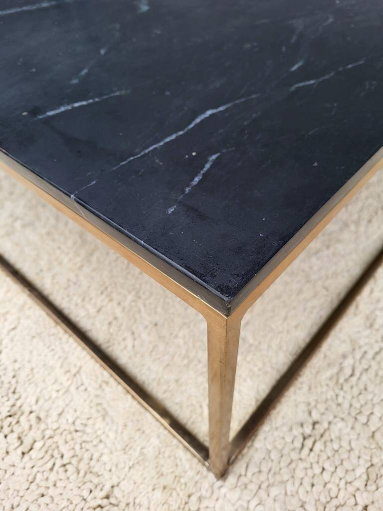 Coffee table or black marble and brass display "in its own juice"