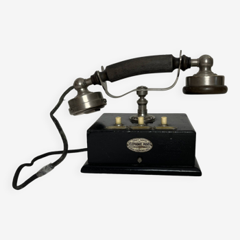 Old desk telephone in blackened wood and bakelite circa 1900