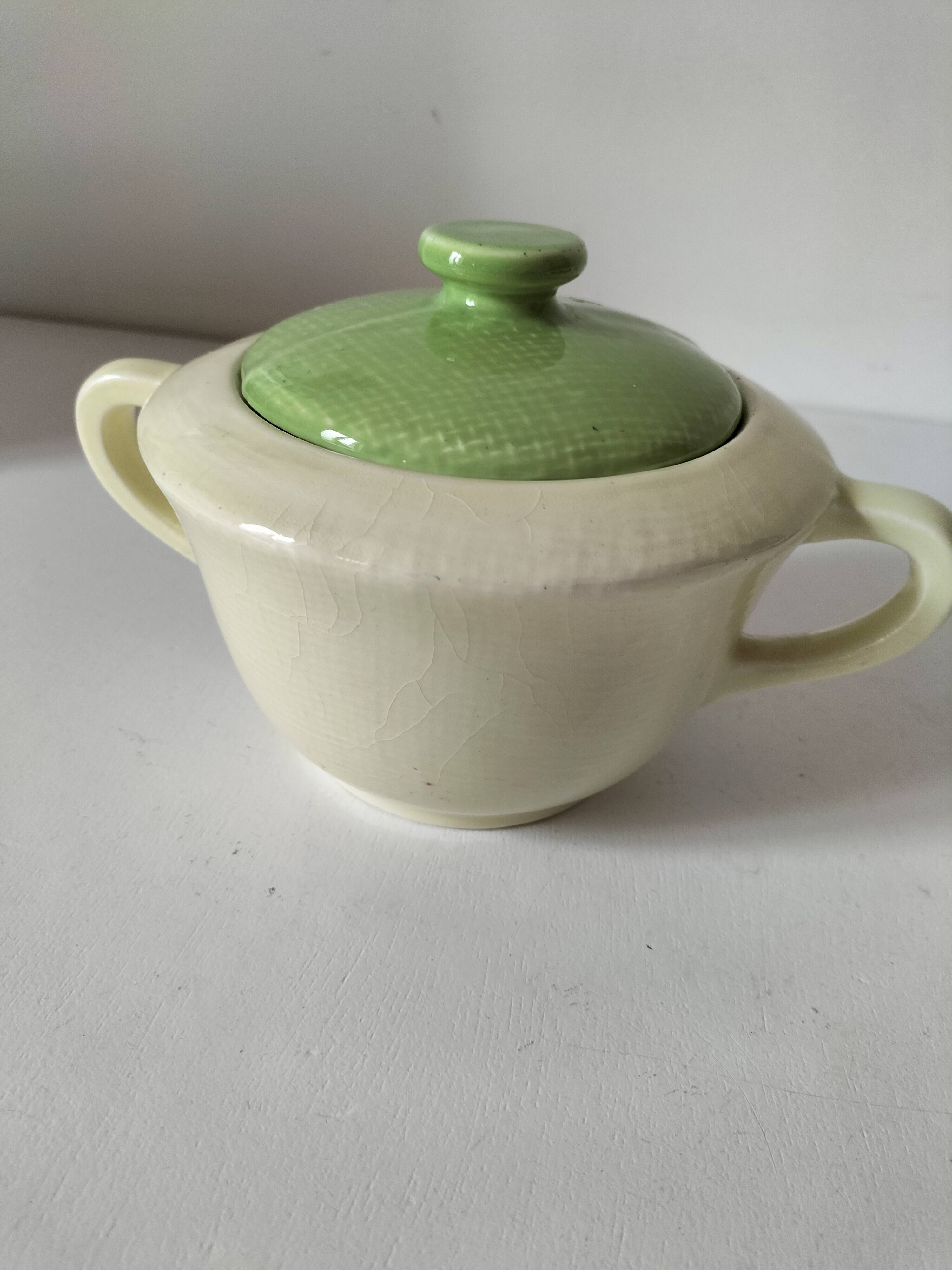 Two sugar bowls and a textured plate in turquoise and green Salins earthenware.