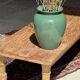 Brown Indonesian teak coffee table, with a border and cylindrical legs H40 L103.