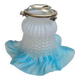 An antique lampshade in frosted glass with delicate blue edges.
