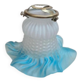 An antique lampshade in frosted glass with delicate blue edges.