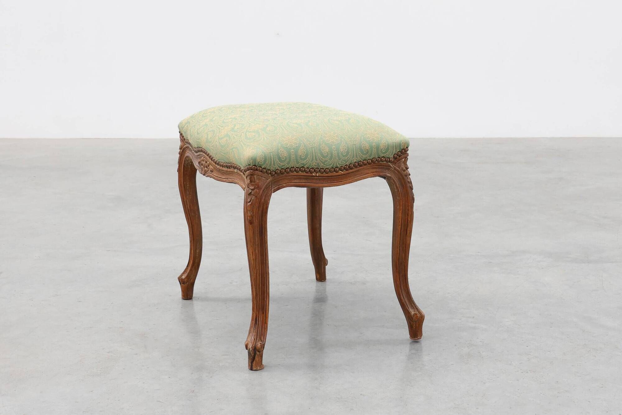 Louis XV stool with carved floral apron and original damask upholstery