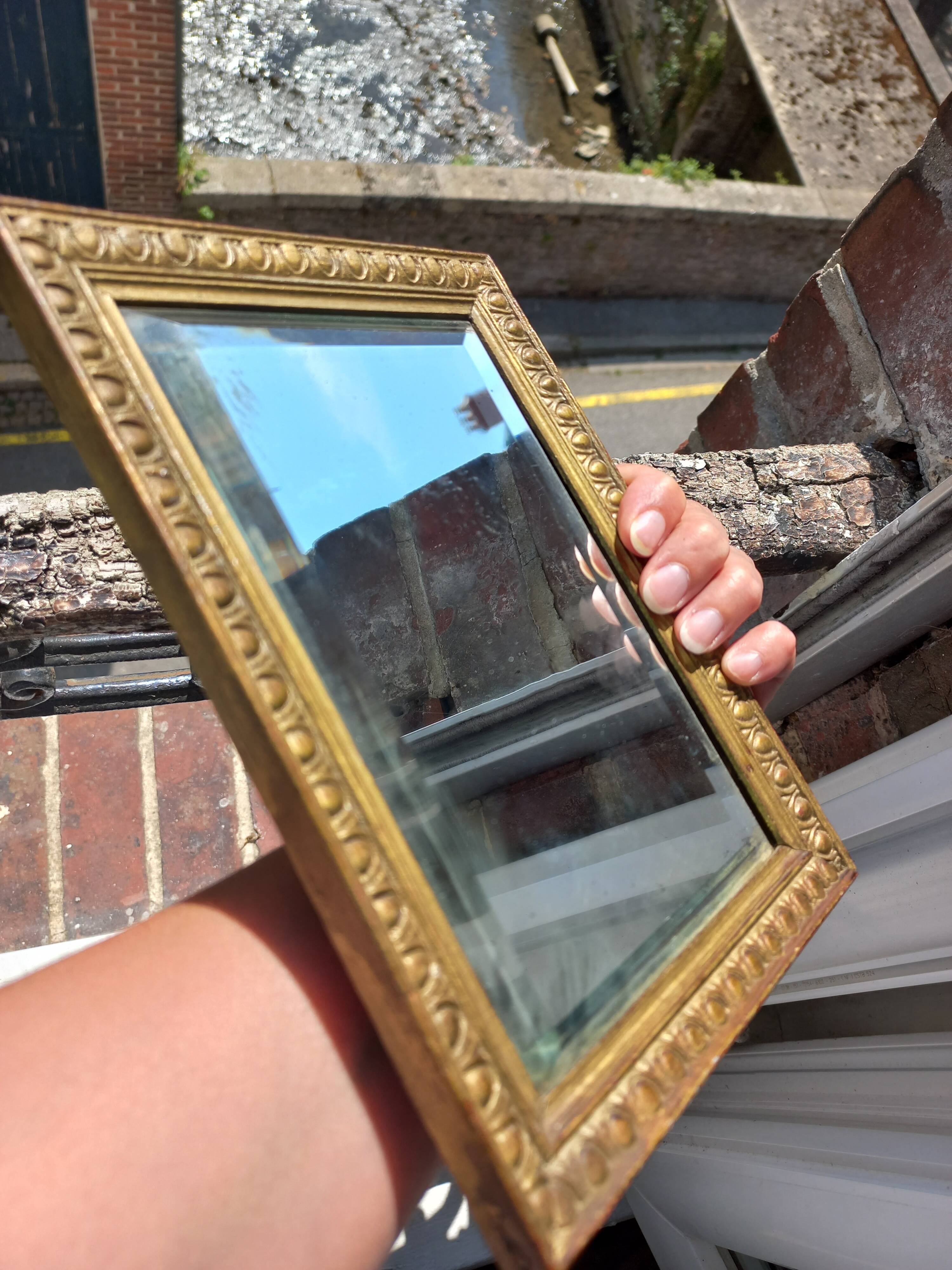 Small vintage mirror in gilded wood, bevelled glass with chain.