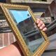 Small vintage mirror in gilded wood, bevelled glass with chain.