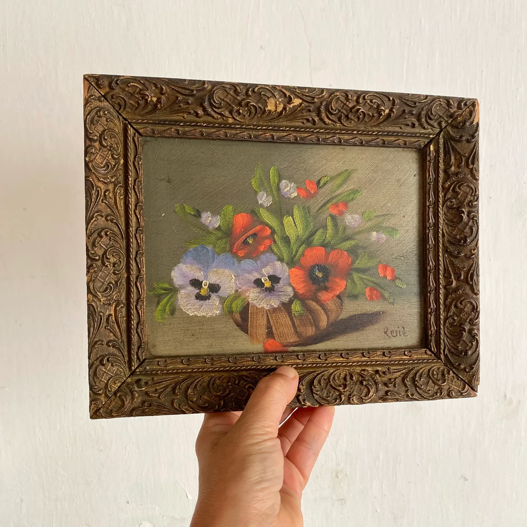 Old painting of a bouquet of pansies and poppies.