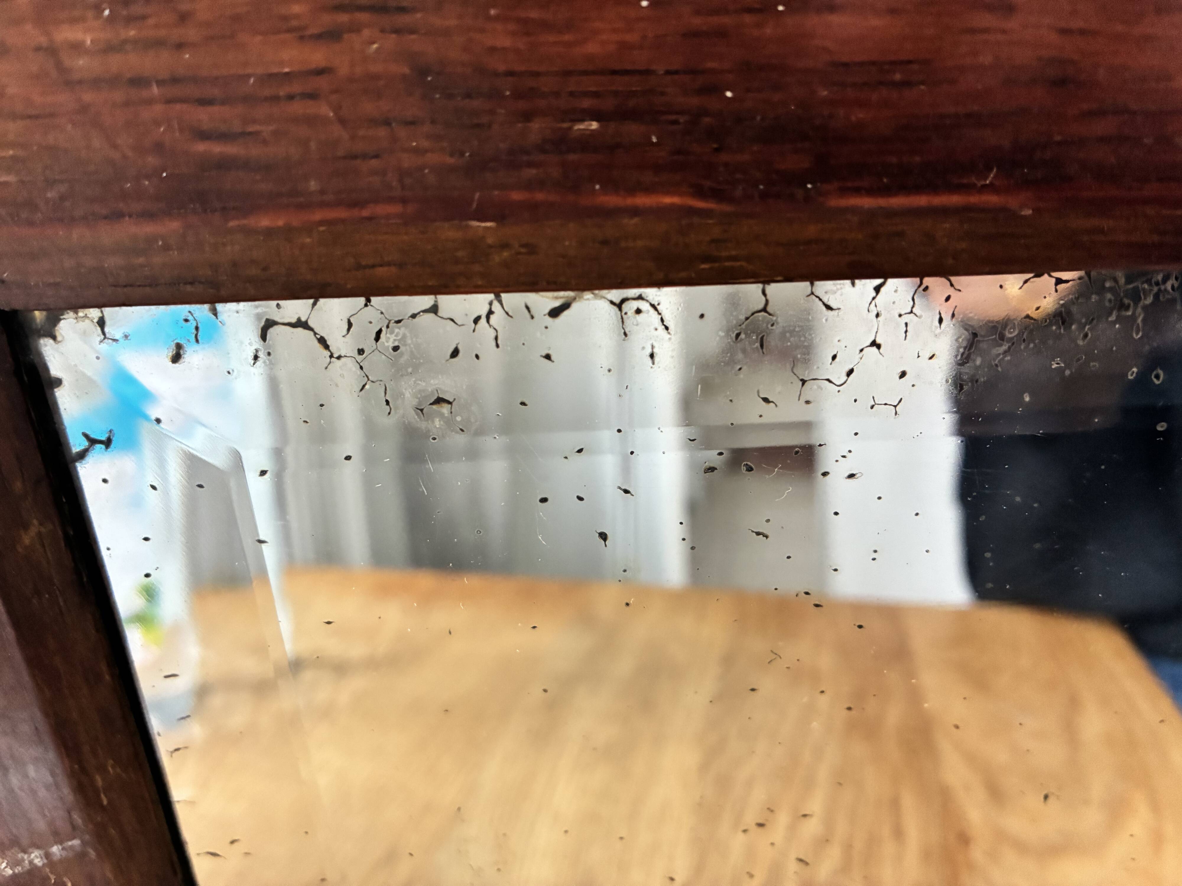 Bevelled mercury mirror with a wooden frame