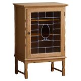 Scandinavian wardrobe in natural oak with a glass front.