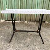 Vintage bistro table with an Art Deco style cast iron base and Formica top.