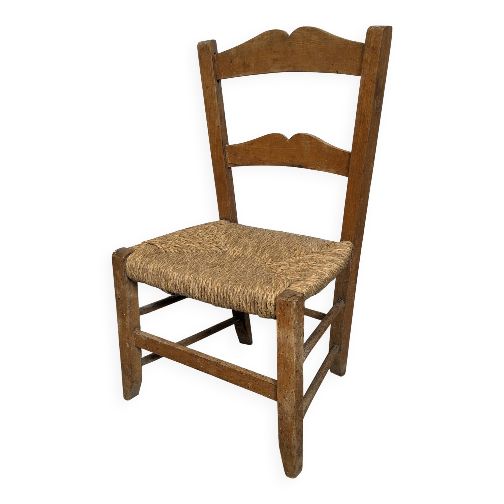 Vintage wooden and straw children's chair in a country style.
