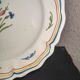 Old plate in earthenware of Nevers eighteenth Century with chantourné edges