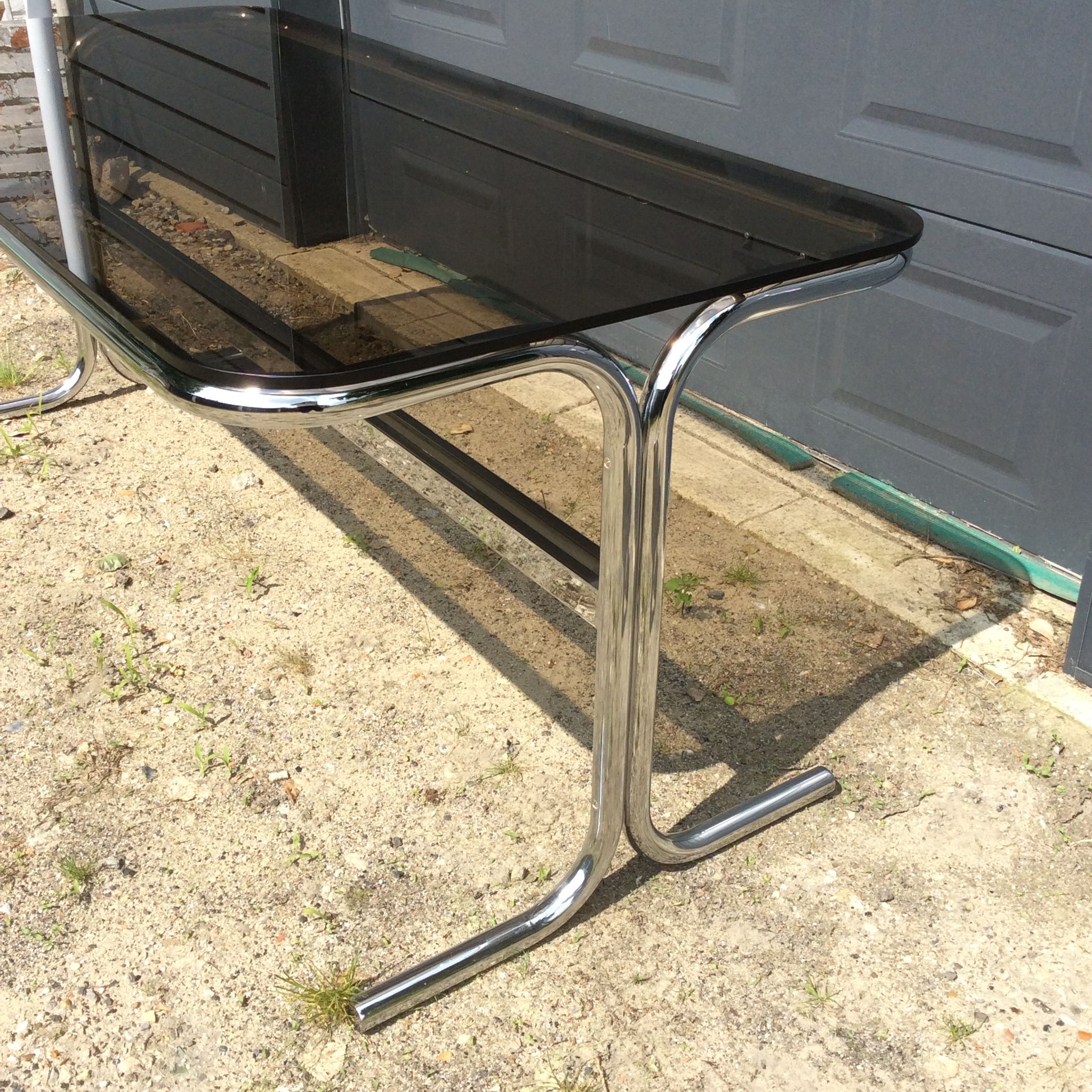 Dining table of the 70s in smoked glass and chromed metal