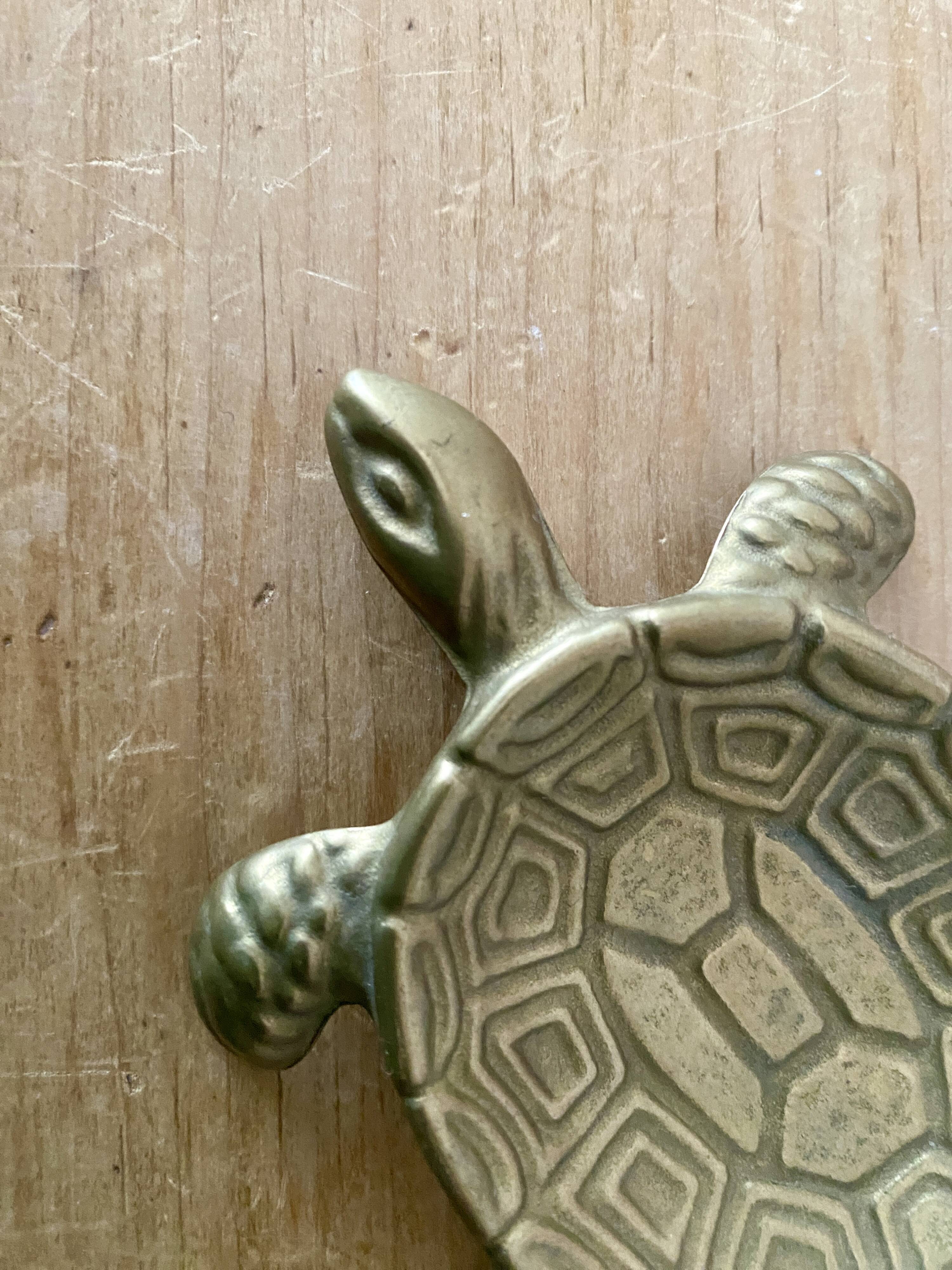 Vintage brass turtle pocket emptier
