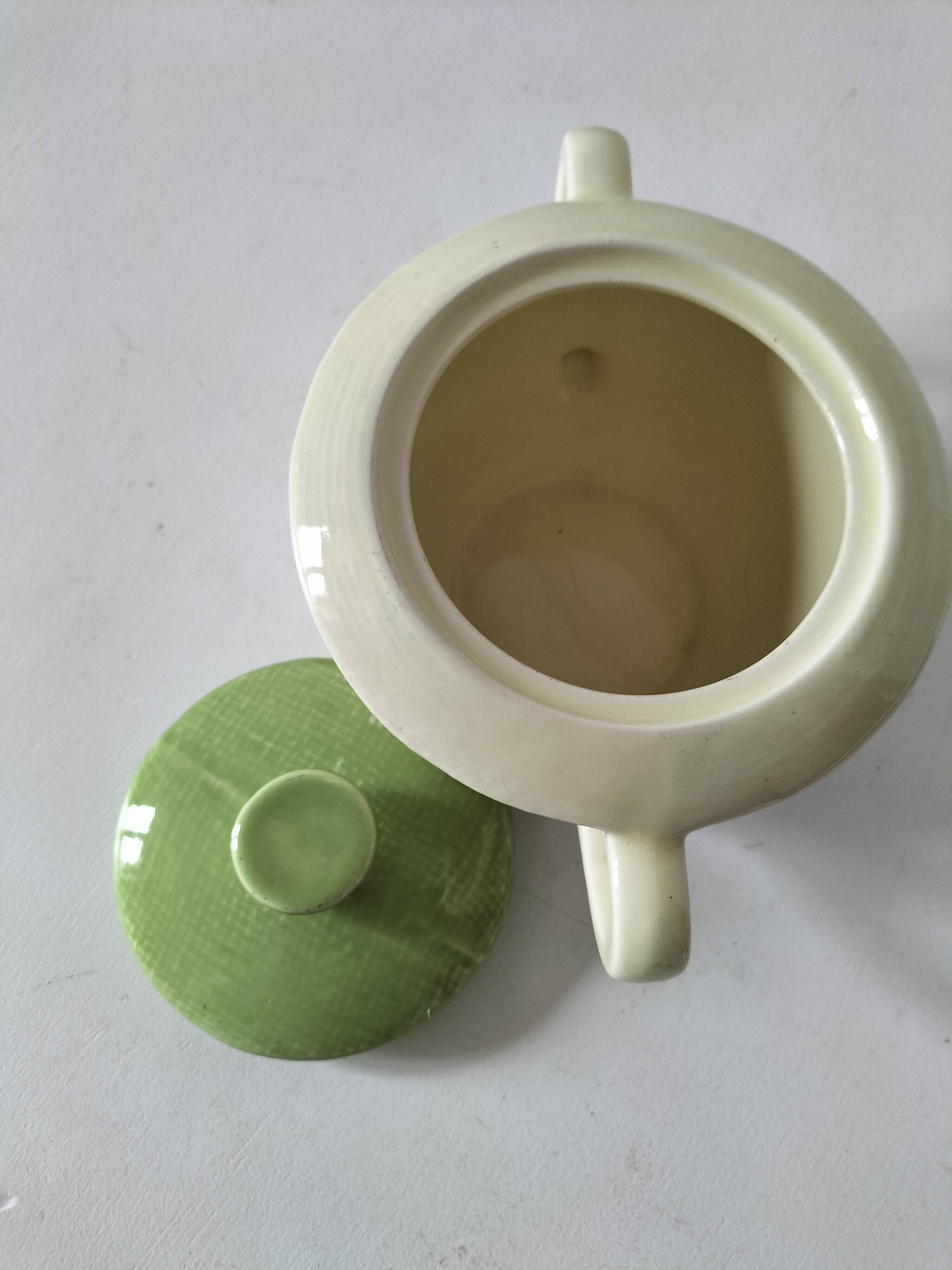 Two sugar bowls and a textured plate in turquoise and green Salins earthenware.