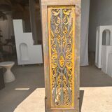 Rectangular Indonesian construction element with blue and yellow plant in carved wood