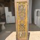 Rectangular Indonesian construction element with blue and yellow plant in carved wood