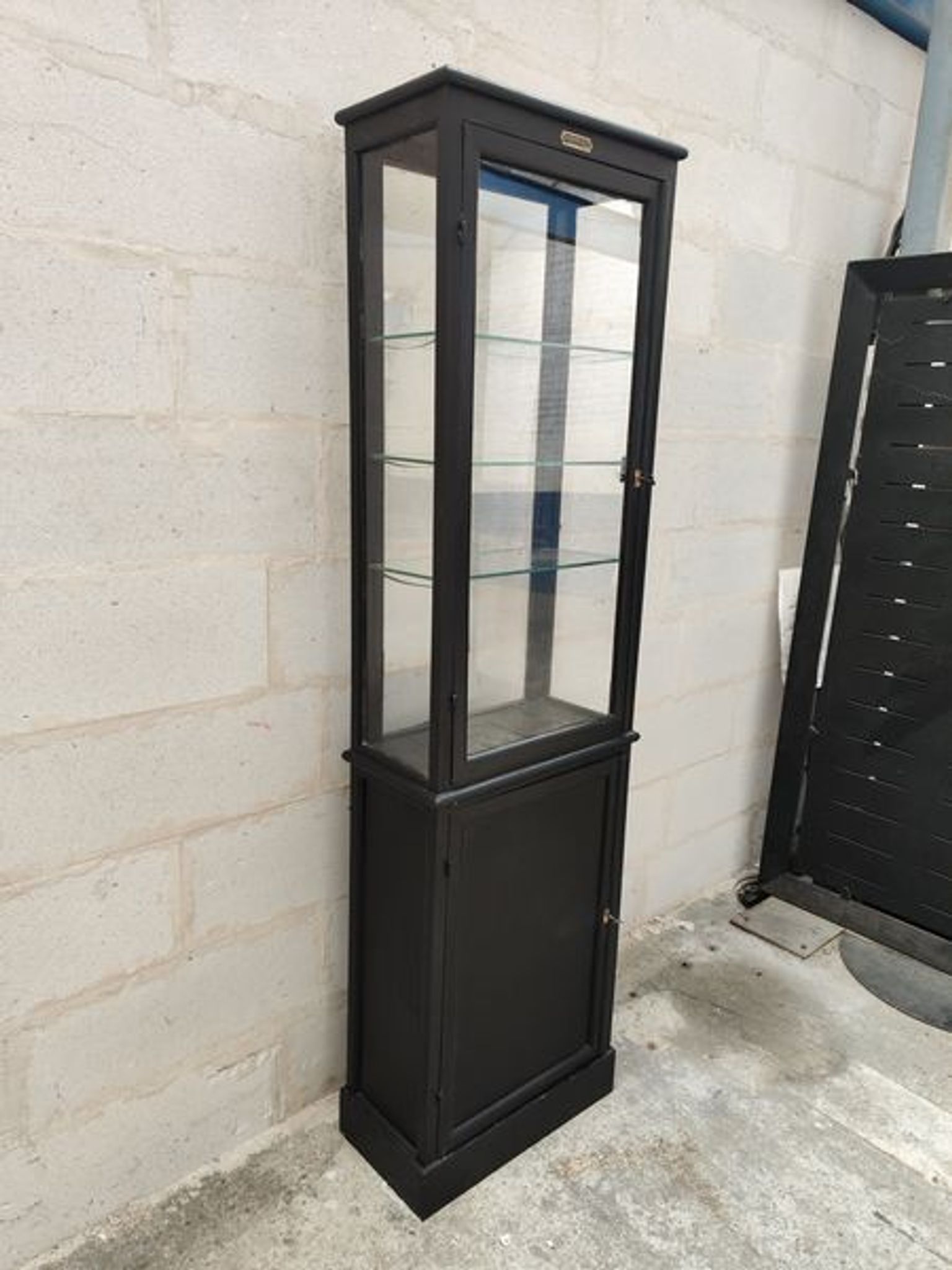 Old wooden window of black patina store two doors